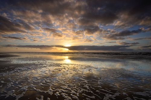 Setting sun at North Sea beach by Martin Jansen