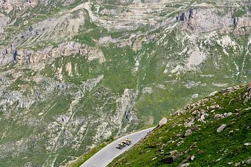Cyclists train in grand mountain scenery by Bram Berkien