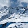 Lonely hiker in an impressive snow and mountain landscape by Ralph Rozema