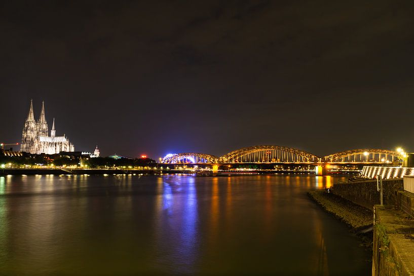 Cologne Cathedral and Hohenzollner Bridge by night by Tom Voelz