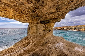 Cave with a view of the rocky coast by Dennis Eckert