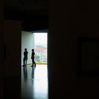 Two silhouettes in large doorway