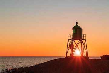 Sunset at the harbor light of Stavoren by Meindert Marinus