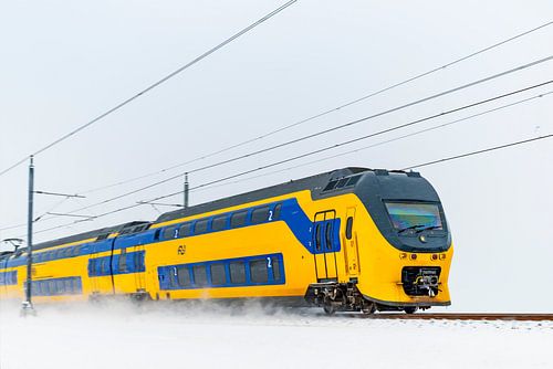 Intercity train driving through the snow