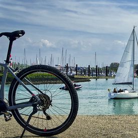A bicycle and a sailing boat at the harbour by Herbert Böck