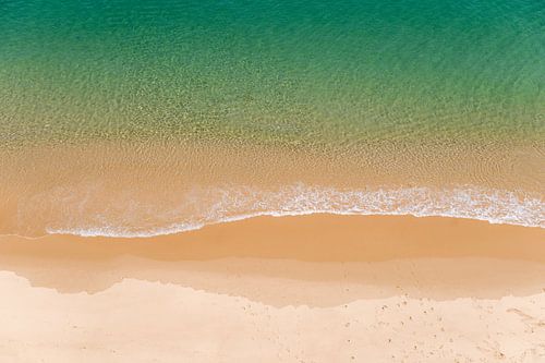 Tranquil image of a beautiful stretch of Portuguese beach and green blue sea