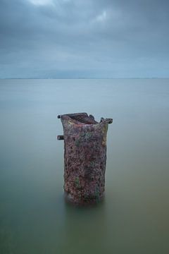 Rusty pole in the water, minimalist by Rick Goede