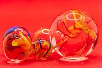 Close up of glass marbles with coloured smoke in the balls