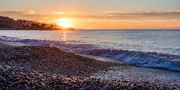 Sunrise on the beach at Menton in France by Werner Dieterich