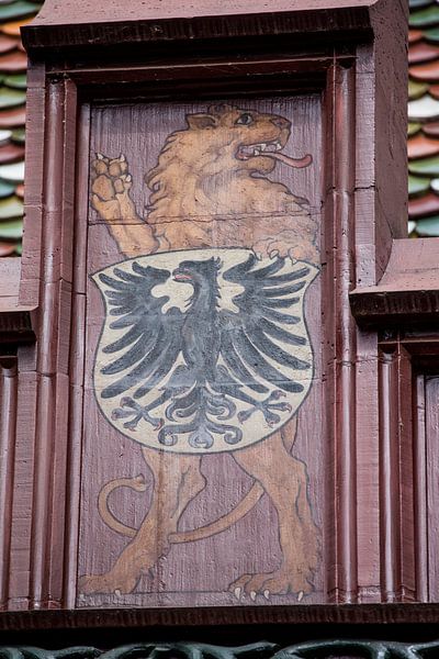 Shield with lion on top of roof of Basel Town Hall in Switzerland by Joost Adriaanse