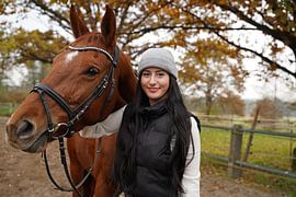 Training with the bay Oldenburg mare on a riding arena