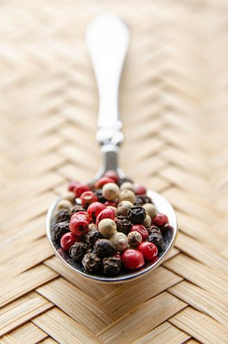 Peppercorns on a silver spoon