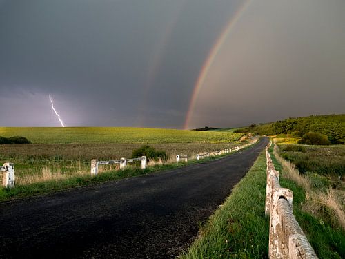 Contrating landscape in hungary with dramatic weather and rainbow.