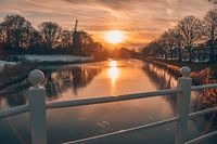 Zonsondergang met molen en ijs