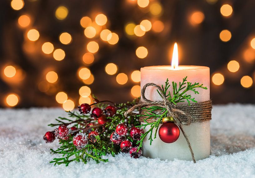 Advent and Christmas time with candle flame and traditional decoration on snow by Alex Winter