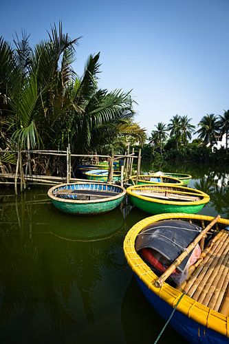 Colourful round boats on a peaceful river