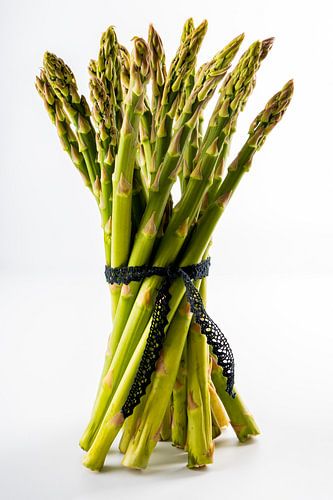 A bundle of fresh green asparagus with white background