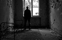 Depressed person standing at a window by Frank Herrmann thumbnail