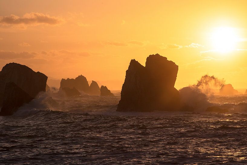 Sunset on a rugged rocky coastline by Peter Haastrecht, van