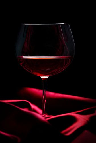 Een glas wijn op rode zijde