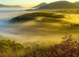 Mountain landscape with fog and sunshine by André Post