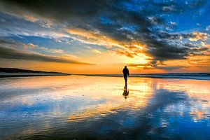 walk on the beach during a sunset. by eric van der eijk