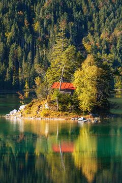 Small island on the bavarian mountain lake Eibsee at sunrise in autumn