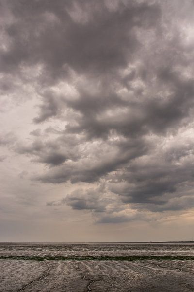 Dark clouds above the Wadden Sea. by Adri Vollenhouw