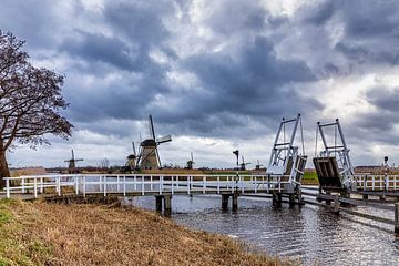 Mills of Kinderdijk behind drawbridge by Kees Dorsman