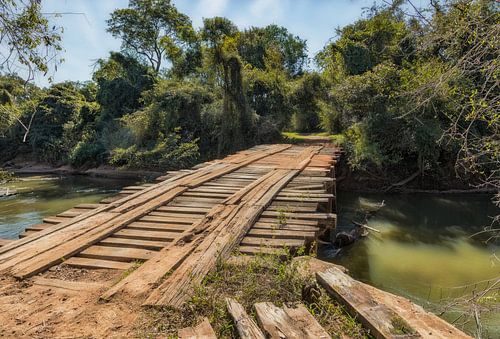 Oude onveilige houten brug zonder leuningen in de wildernis van Paraguay.