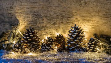 Décoration traditionnelle de Noël avec pommes de pin, lumières festives sur Alex Winter