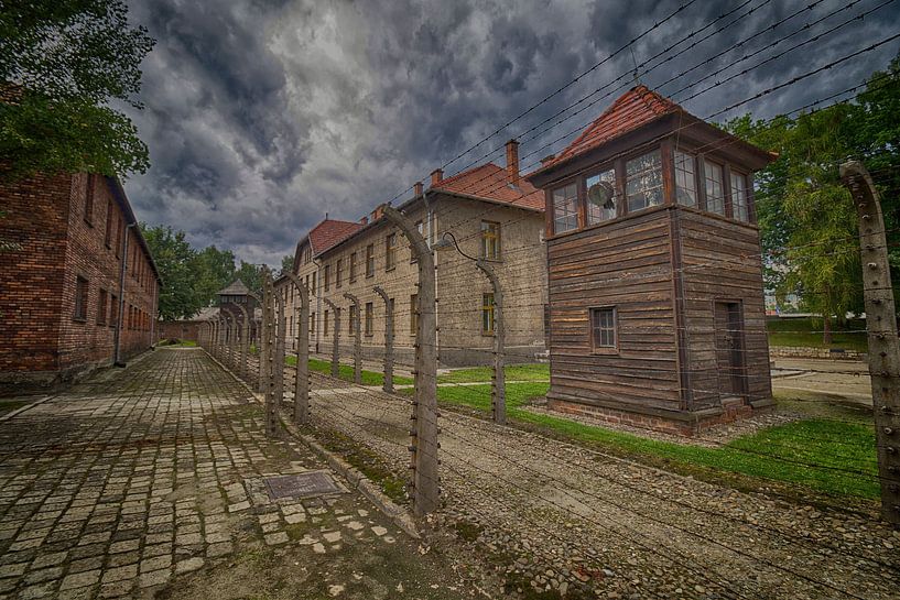 The watch tower and barbed wire fences of Auschwitz by Caught By Light
