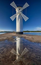 Mill beacon on the pier in Swinemünde, completely reflected in a puddle by Stefan Dinse