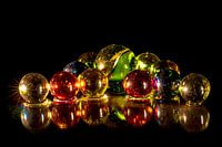 mirrored coloured glass beads on black background