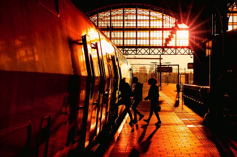 Travelers boarding a train at Sunset by Rob Kints