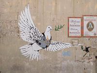 Peace pigeon in bulletproof vest by Banksy