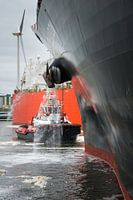 Tug Water Street standing by ship's bow