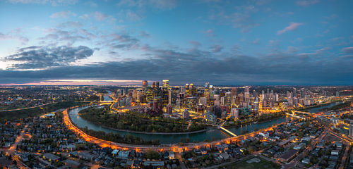Calgary at twilight – the illuminated skyline and the Bow River
