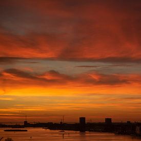 Beautiful red-orange sky just before sunrise over Amsterdam by Thijs van Laarhoven