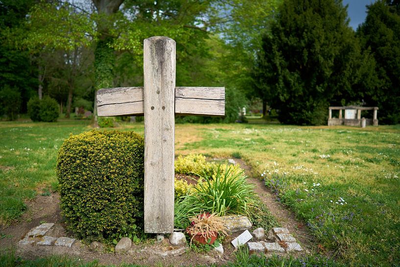 Wooden cross at a grave in a cemetery of the city of Magdeburg by Heiko Kueverling