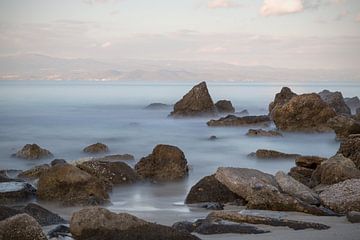 Greek coastline with rocks and sea in the foreground by Miranda van Hulst