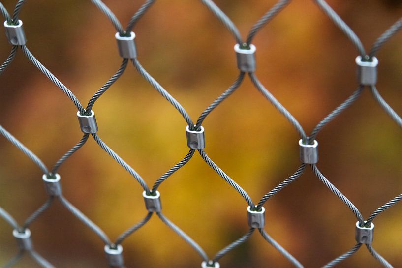 Fence in front of autumn colors van Marco de Groot