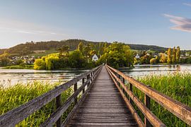 Historic wooden bridge leading to the monastery island of Werd near Stein am Rhein in the evening light