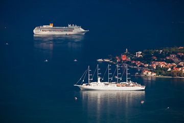 Beautiful cruise ships (one sailing) are far below among the dark blue near the town with red roofs, by Michael Semenov