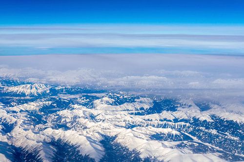 Snow Covered Alps Mountains Aerial View over the Clouds