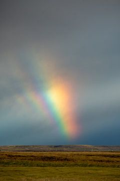 Beautiful rainbow in the sky of Iceland with mountain and landsc