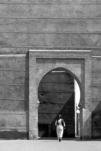 Une femme traverse une porte dans le centre de Marrakech.