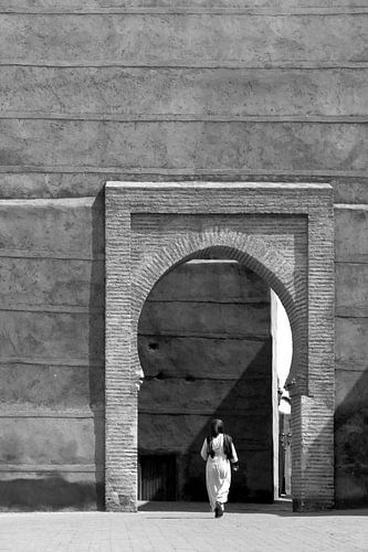 Woman walks through a gate in the center of Marrakech by Evelien Oerlemans