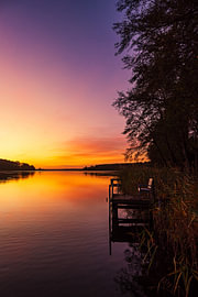 Sunrise with a jetty and a tree at Lake Plau by Rico Ködder