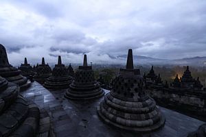 Sfeervolle plaat van de Borobudur voor zonsopkomst op een dag met zware bewolking en neerslag van Arthur Puls Photography